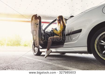 To Get Rich. Beautiful Successful Gorgeous Girl Sitting In The Convertible Cabrio Car On The Warm Su