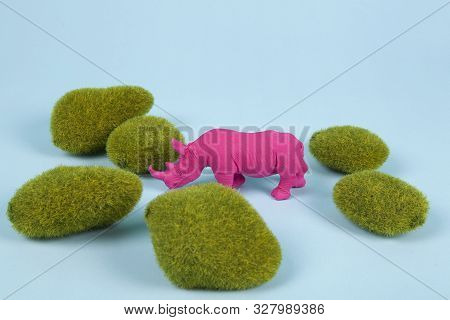 Moss Rocks And Pink Pop Plastic Rhinoceros