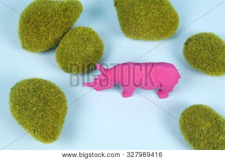 Moss Rocks And Pink Pop Plastic Rhinoceros