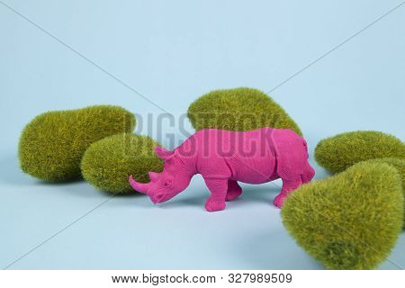 Moss Rocks And Pink Pop Plastic Rhinoceros