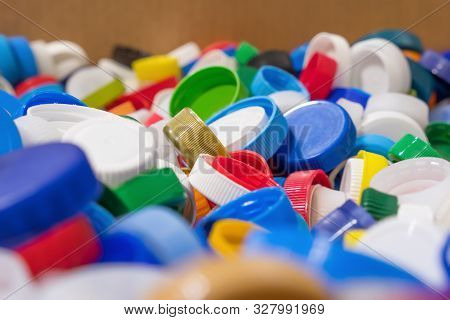 Plastic Garbage Background. Plastic Caps Of Different Colors. Risk Of Health For Humans And Environm