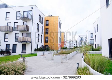 Sidewalk In A Cozy Courtyard Of Modern Apartment Buildings Condo With White Walls. No People.  Real 