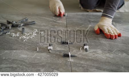 Plastic Cross For Leveling Tiles During Construction Or Renovation. Floor Tile Repair. Installation 