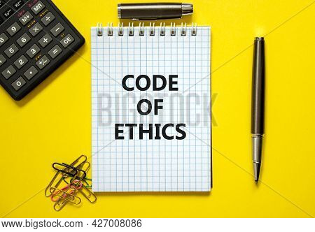 Code Of Ethics Symbol. Words 'code Of Ethics' On White Note. Yellow Background, Paper Clips, Metalli