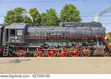 Black Retro Steam Locomotive At The Railway Station On A Sunny Day