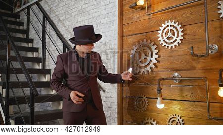 Magical Lighting Of A Light Bulb. Businessman Demonstrating Magic. Magician At Work. Entertainer Per