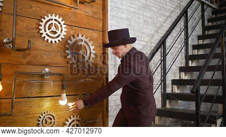 Magical Lighting Of A Light Bulb. Businessman Demonstrating Magic. Magician At Work. Entertainer Per