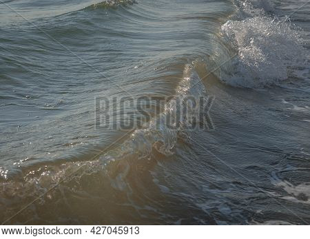 Colored Sea Waves With Splashes And White Breakers In Circeo Park, Sabaudia, Italy