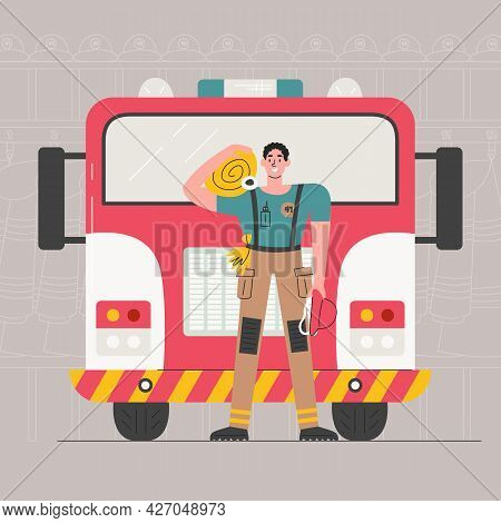 Young Adult Firefighter Holding Rescue Equipment. Fireman Standing In Uniform In Front Of Firetruck 