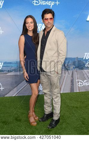 LOS ANGELES - JUL 15:  Caitlin McHugh, John Stamos at Disney+ 