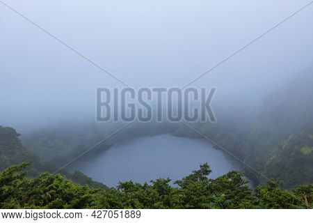 Deep lake in Flores Island, Azores Archipelago, Portugal. Green lagoon with green vegetation