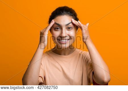 Close Up Portrait Of Young Indian American Woman Touching Face Skin Her Hands And Doing Self Yoga Fa