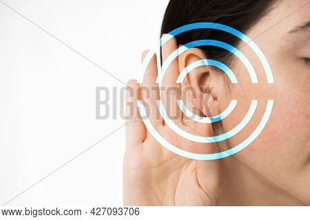 Hearing Test. A Young Woman Holds Her Hand To Her Ear, Close-up. Isolated On A White Background. Cop