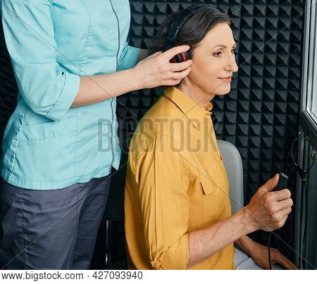 Hearing Test To Mature Woman. Senior Woman During Hearing Test And Audiometry At Hearing Clinic With