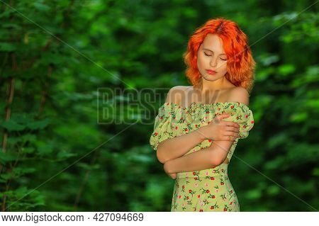 Woman In Dress Standing On A Background Of Green Foliage In Summer Forest. Shallow Dof
