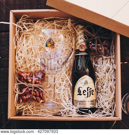 Lviv, Ukraine - December 1, 2017: Leffe Beer Bottle And Glass Cup With Label And Salted Nuts Snacks 