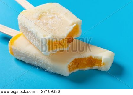 Shredded Pork Popsicles With Bites On A Blue Background