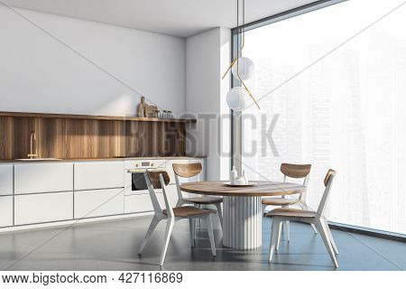 Corner Of The Interior With The White Panoramic Kitchen Area. Wooden Table, Chairs And Splashback Of