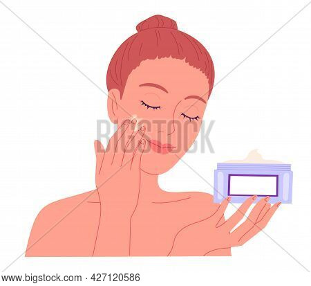 Young Woman Applying Cream To Her Face