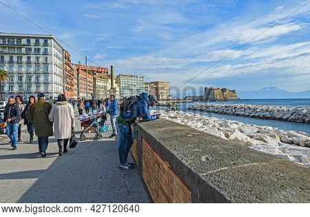 Naples, Italy - January 21, 2017: People Strolling The Lungomare Caracciolo,  Romantic Seaside Prome