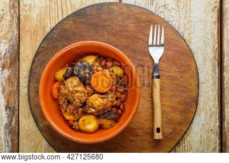 Jewish Dish Chelnt With Meat On The Table In A Plate On A Round Stand. Horizontal Photo