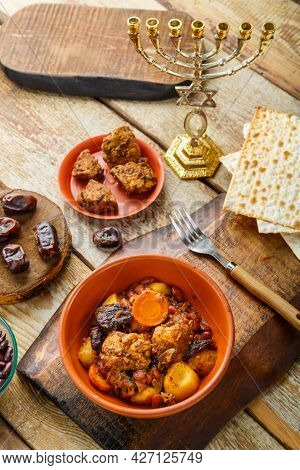 Jewish Dish Shut With Meat On A Wooden Table Near Matzo And Ingredients. Vertical Photo