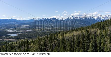 Forest Valley With Mountains In Background, Shot At Mt Yamnuska Trail, Canadian Rockies, Alberta, Ca