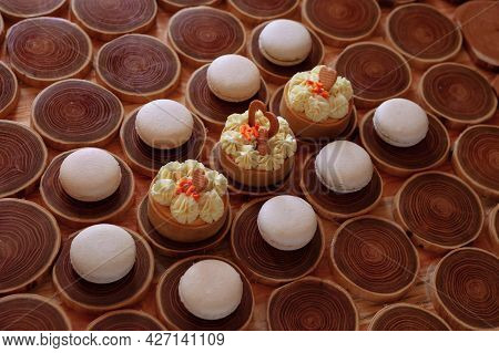 White Delicate Lowly Macaroons On A Wooden Background. The Pastel Tone Of The Cream Inside The Frenc