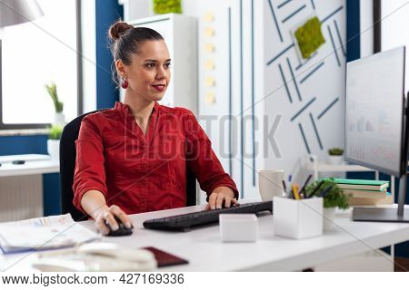 Freelancer In Office Sitting At Desk Typing On Computer Keyboard And Cliking On Mouse Working On Exp