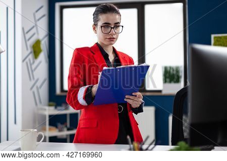 Entrepreneur Standing In Corporate Office Workplace Taking Notes On Clipboard While Doing Financial 