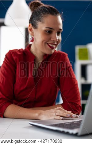 View Of Businesswoman Typing On Laptop And Using Touchped, In Corprate Business Workplace Building. 