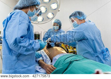 Medical Team In Surgical Gown Help Patient To Making Cpr Cardio Pulmonary Resuscitation In The Opera