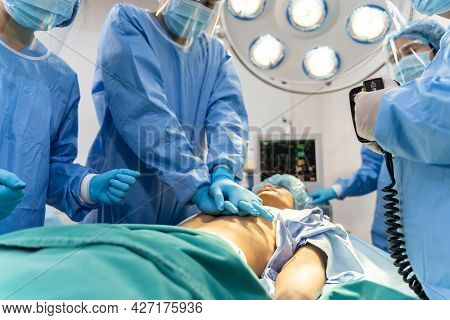 Medical Team In Surgical Gown Help Patient To Making Cpr Cardio Pulmonary Resuscitation In The Opera