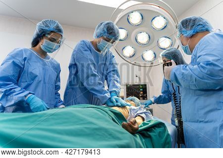 Medical Team In Surgical Gown Help Patient To Making Cpr Cardio Pulmonary Resuscitation In The Opera