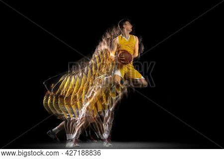 Power And Speed. One Young Basketball Player Training With Ball Isolated On Dark Background With Str