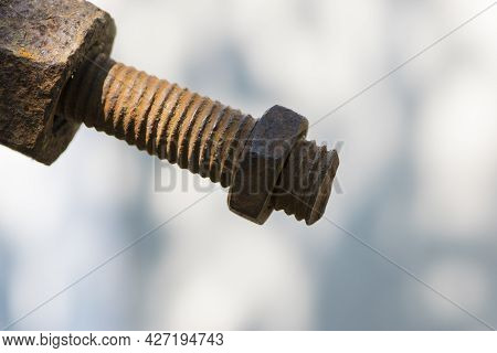 Old Rusty Bolt, Iron Rod With Screw Threads. Rusted Mechanical Components. Threaded Bolt And Nut Iso
