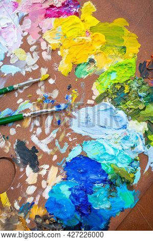 Palette With Multi-colored Paints And Brushes, Woman Painting Picture