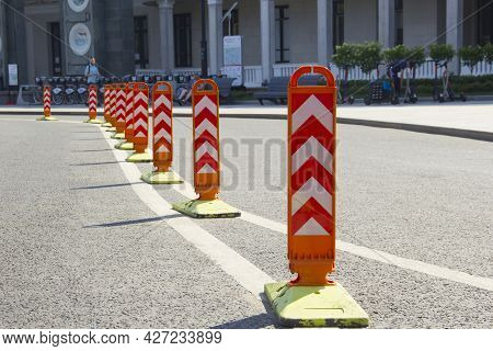 Orange Road Dividers. Curved Line Of Dividing Posts On The Double Road Marking Line.