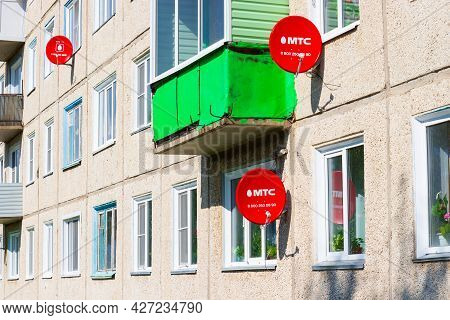 Krasnoyarsk, Russia - July 15, 2021: Mts Satellite Tv Dishes On The Facade Of The Panel Residential 