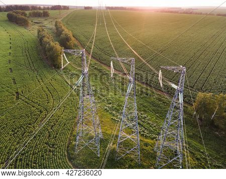 High Voltage Power Line On Industrial Electricity Line Tower For Electrification Rural Countryside. 