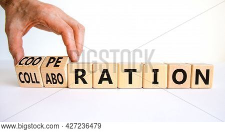 Cooperation Or Collaboration Symbol. Businessman Turns Cubes, Changes Words 'collaboration' To 'coop