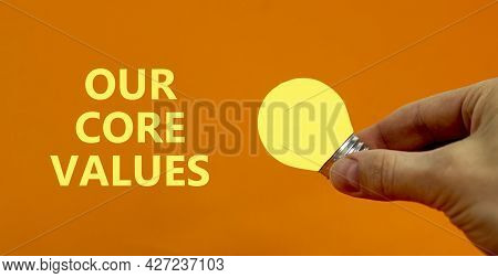Our Core Values Symbol. Businessman Holds Yellow Shining Light Bulb. Words 'our Core Values'. Beauti
