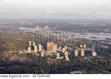 Aerial View From Airplane Of Residential Homes And Buildings In A Modern City During Sunny Summer Su