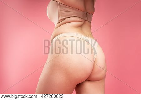 Overweight Woman With Fat Thighs And Buttocks, Obesity Female Legs On Pink Background