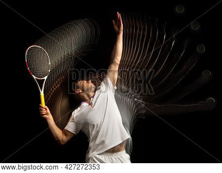 Portrait Of Young Man, Male Tennis Player In Motion And Action Isolated On Dark Background. Strobosc
