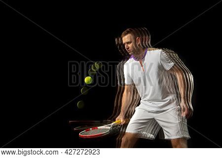 Portrait Of Young Man, Male Tennis Player In Motion And Action Isolated On Dark Background. Strobosc