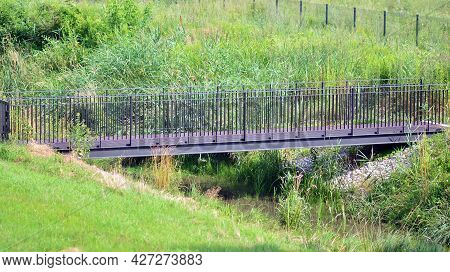 Metal Concrete Stone Bridge With Rails Over The River