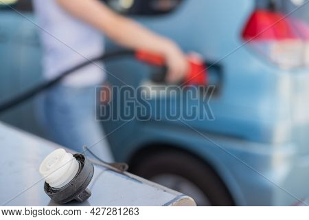 Caucasian Woman Refueling A Car At A Self-service Gas Station.