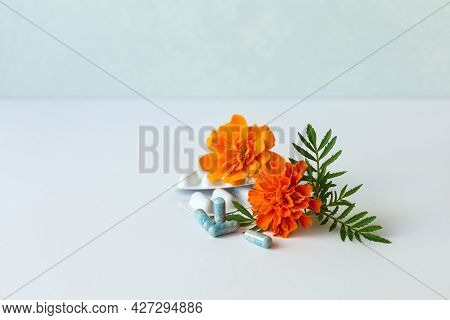 Dietary Supplement Capsules Of Marigold Flowers On White Background. Concept: Vision Improvement, Ey