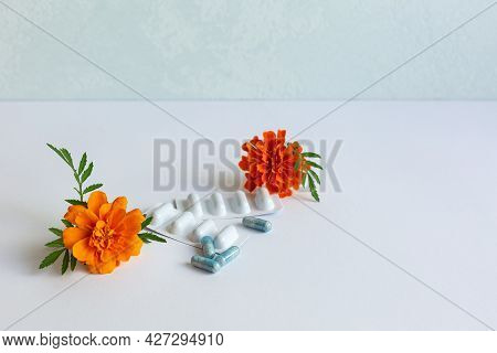 Dietary Supplement Capsules Of Marigold Flowers On White Background. Concept: Vision Improvement, Ey